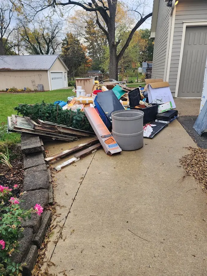 Dumpster being loaded with debris for Residential Dumpster Rental in Holly Springs